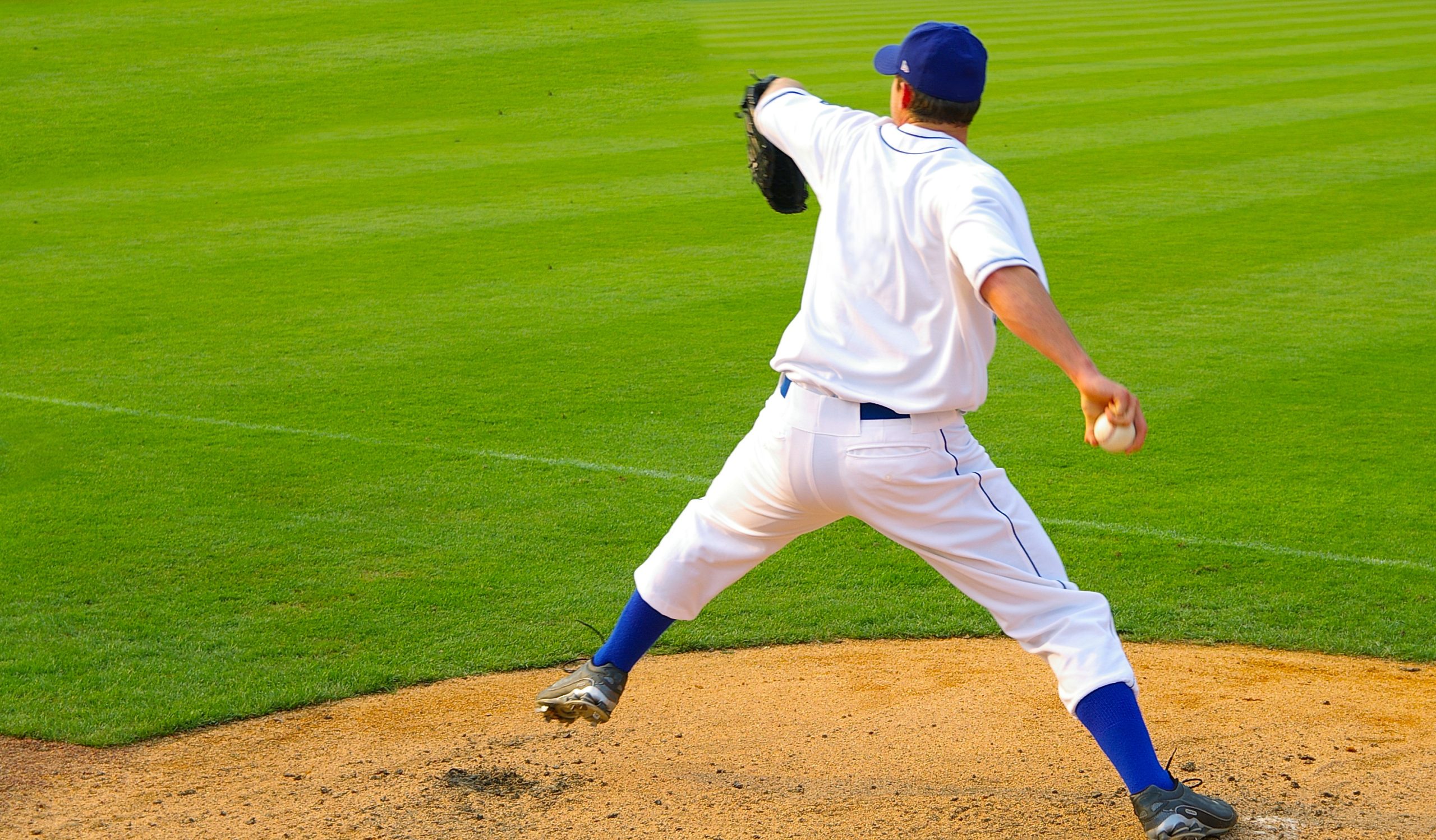 Professional baseball pitcher throwing the ball